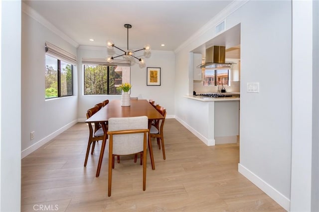 dining space featuring a chandelier, crown molding, baseboards, light wood-type flooring, and recessed lighting