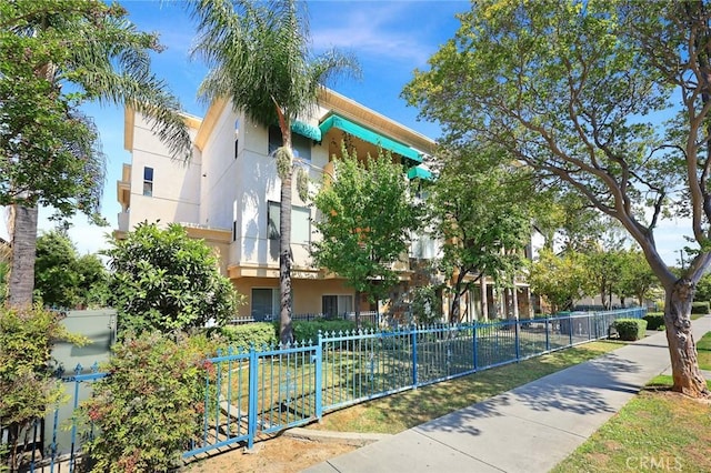 view of building exterior with fence