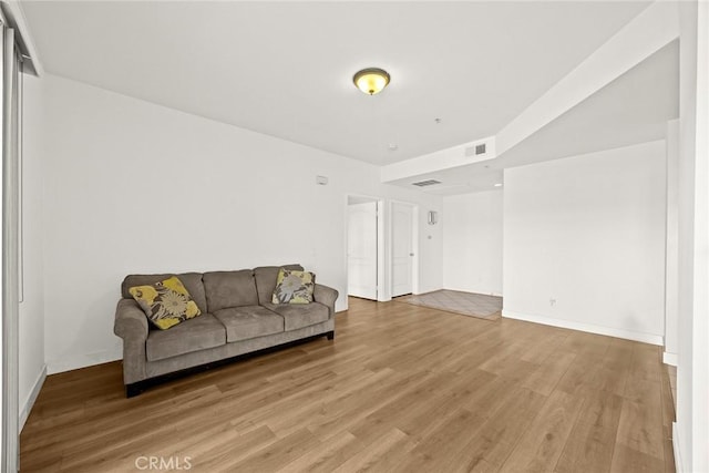 living area with light wood-style floors and baseboards