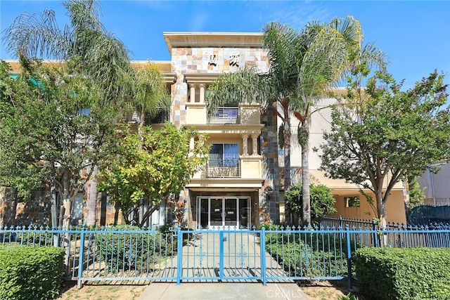 view of building exterior with a fenced front yard