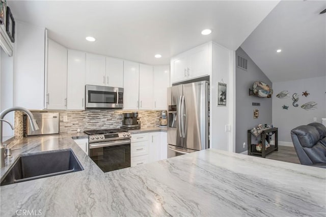 37 Fleurance St, Laguna Niguel, CA 92677 - kitchen featuring appliances with stainless steel finishes, a sink, light stone countertops, backsplash, and recessed lighting