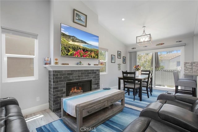 37 Fleurance St, Laguna Niguel, CA 92677 - living room featuring a chandelier, lofted ceiling, wood finished floors, a brick fireplace, and baseboards