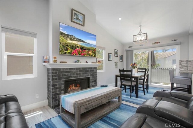 37 Fleurance St, Laguna Niguel, CA 92677 - living area with a chandelier, wood finished floors, lofted ceiling, and a fireplace