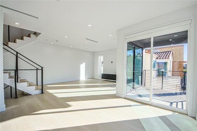 2202 Thurman Ave, Los Angeles, CA 90016 - unfurnished living room featuring stairs, wood finished floors, and recessed lighting
