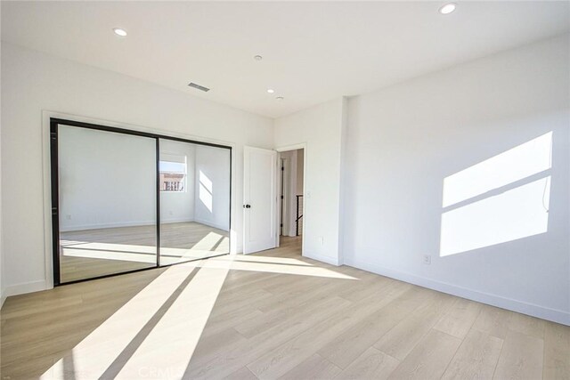 2202 Thurman Ave, Los Angeles, CA 90016 - unfurnished bedroom featuring light wood-style floors, recessed lighting, baseboards, and a closet