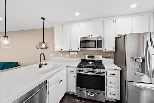 12750 Centralia St Unit 215, Lakewood, CA 90715 - kitchen with stainless steel appliances, a sink, light countertops, white cabinets, and recessed lighting