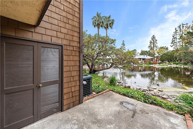 12750 Centralia St Unit 215, Lakewood, CA 90715 - view of patio / terrace with a water view and central air condition unit