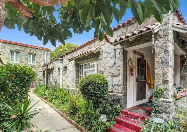 581 N Euclid Ave, Upland, CA 91786 - doorway to property with stone siding and a tile roof