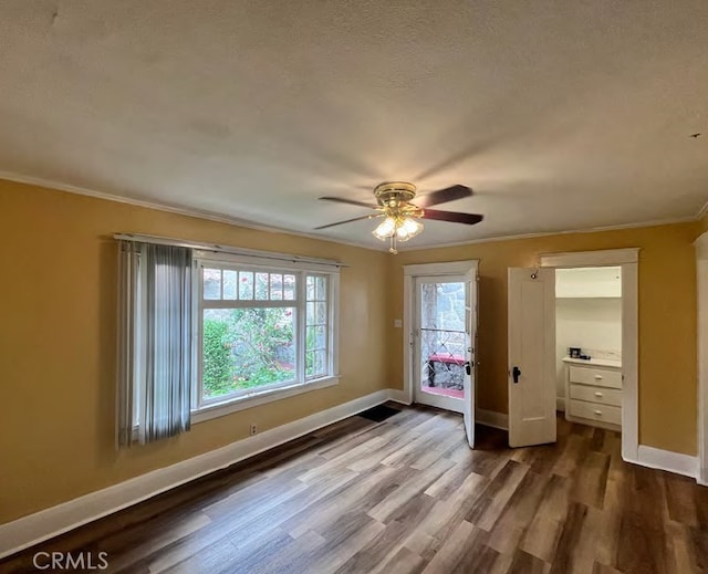 581 N Euclid Ave, Upland, CA 91786 - unfurnished bedroom with crown molding, dark wood-style floors, baseboards, and a ceiling fan