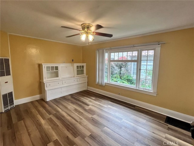581 N Euclid Ave, Upland, CA 91786 - unfurnished living room with ceiling fan, a heating unit, baseboards, dark wood-style floors, and ornamental molding