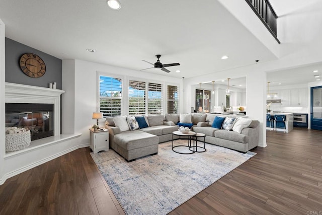 34056 Vandale Ct, Temecula, CA 92592 - living room featuring a ceiling fan, a glass covered fireplace, recessed lighting, dark wood finished floors, and baseboards
