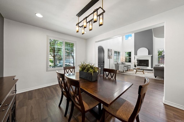 34056 Vandale Ct, Temecula, CA 92592 - dining area featuring plenty of natural light, dark wood-type flooring, a fireplace with raised hearth, and recessed lighting