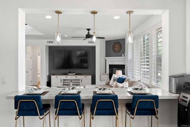 34056 Vandale Ct, Temecula, CA 92592 - living room with recessed lighting, ceiling fan, and a glass covered fireplace