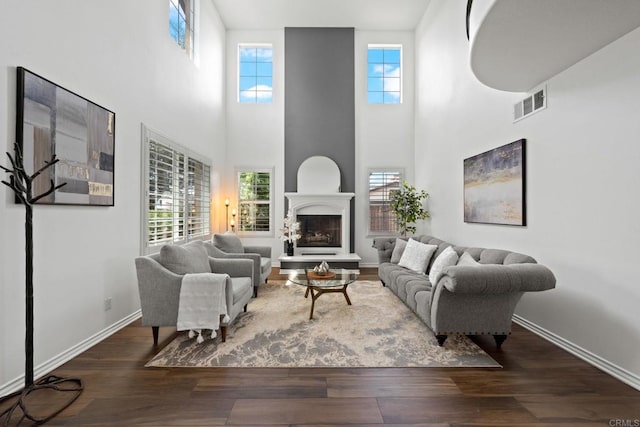 34056 Vandale Ct, Temecula, CA 92592 - living area with wood finished floors, healthy amount of natural light, a fireplace with raised hearth, and a high ceiling