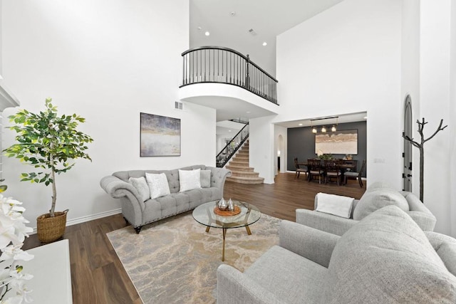 34056 Vandale Ct, Temecula, CA 92592 - living area featuring stairs, wood finished floors, a high ceiling, a chandelier, and baseboards