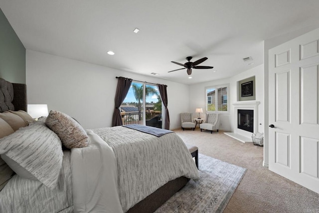 34056 Vandale Ct, Temecula, CA 92592 - bedroom featuring access to exterior, light carpet, a ceiling fan, a glass covered fireplace, and recessed lighting