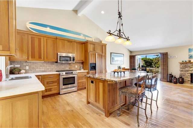 33441 N Spinnaker Dr N, Dana Point, CA 92629 - kitchen with appliances with stainless steel finishes, a sink, light wood-style flooring, backsplash, and beamed ceiling