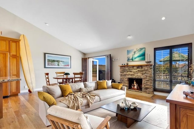 33441 N Spinnaker Dr N, Dana Point, CA 92629 - living room with vaulted ceiling, light wood-type flooring, a fireplace, recessed lighting, and baseboards