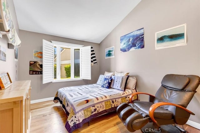 33441 N Spinnaker Dr N, Dana Point, CA 92629 - bedroom with light wood-style floors, vaulted ceiling, and baseboards
