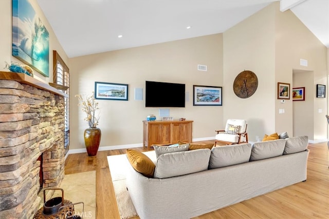 33441 N Spinnaker Dr N, Dana Point, CA 92629 - living room with high vaulted ceiling, light wood finished floors, baseboards, and a fireplace