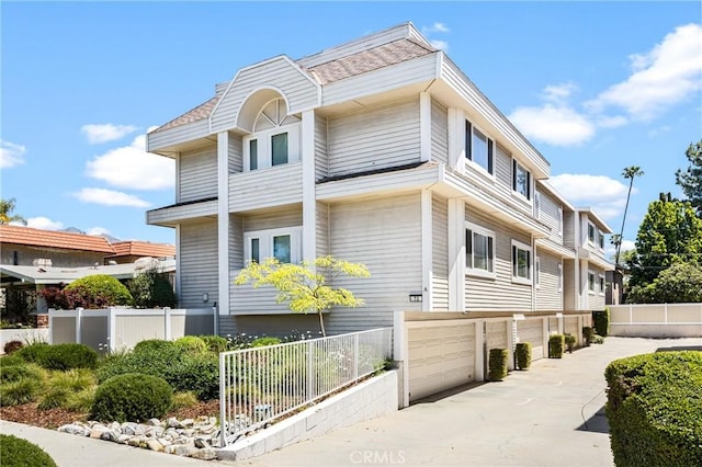 72 S Greenwood Ave Unit 3, Pasadena, CA 91107 - view of property exterior with fence, concrete driveway, and an attached garage