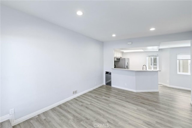 72 S Greenwood Ave Unit 3, Pasadena, CA 91107 - unfurnished living room with recessed lighting, light wood-type flooring, baseboards, and a sink