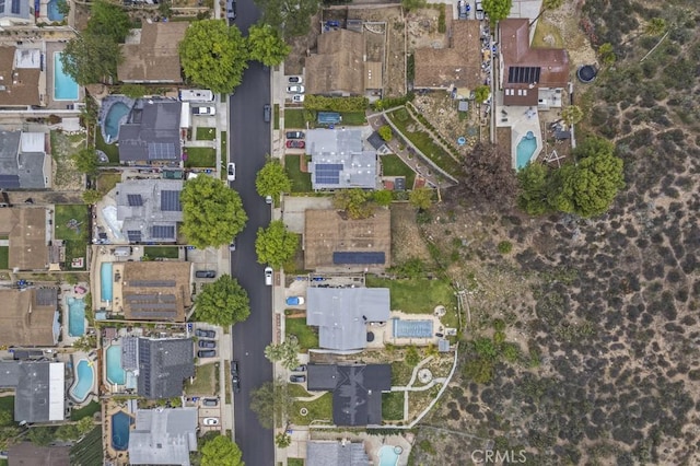 aerial view of property and surrounding area featuring a pool