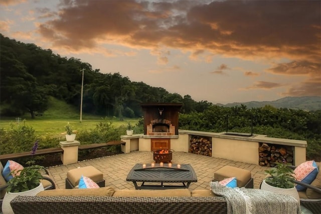 7550 Mary Hall Rd, Arroyo Grande, CA 93420 - patio terrace at dusk featuring an outdoor living space with a fireplace