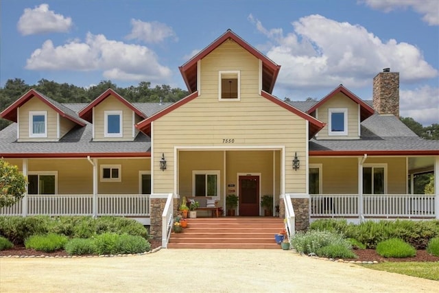 7550 Mary Hall Rd, Arroyo Grande, CA 93420 - view of front facade featuring covered porch, roof with shingles, stone siding, and a chimney