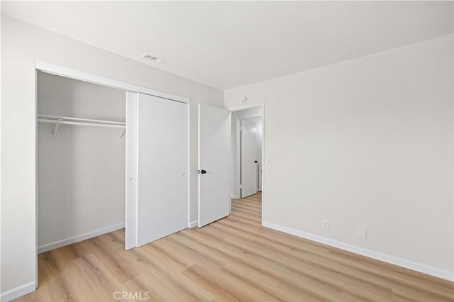 3316 Roxbury St, Rosamond, CA 93505 - unfurnished bedroom with light wood finished floors and a closet