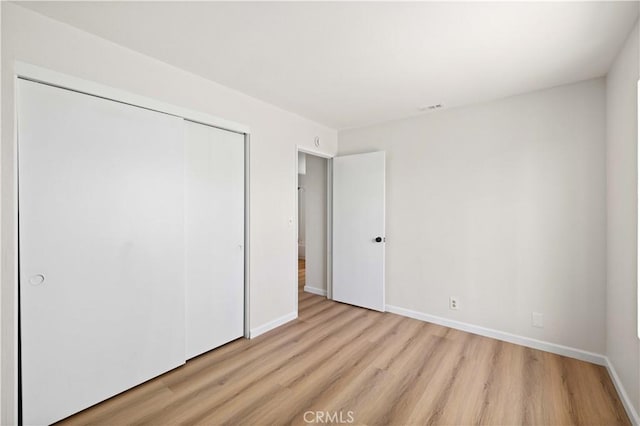 3316 Roxbury St, Rosamond, CA 93505 - unfurnished bedroom with light wood finished floors and a closet