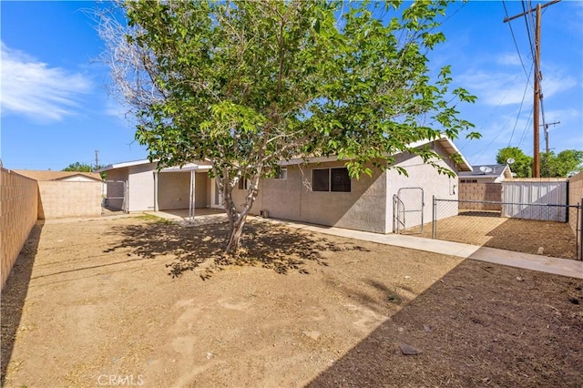 3316 Roxbury St, Rosamond, CA 93505 - view of front of house featuring a gate, stucco siding, and a fenced backyard