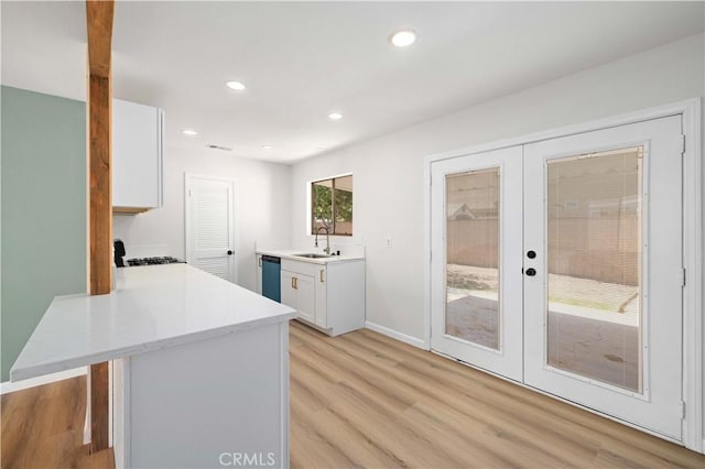 3316 Roxbury St, Rosamond, CA 93505 - kitchen with french doors, dishwasher, light countertops, light wood-style floors, and recessed lighting