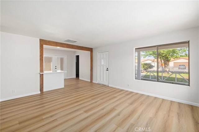 3316 Roxbury St, Rosamond, CA 93505 - unfurnished living room featuring french doors, light wood-style floors, and baseboards