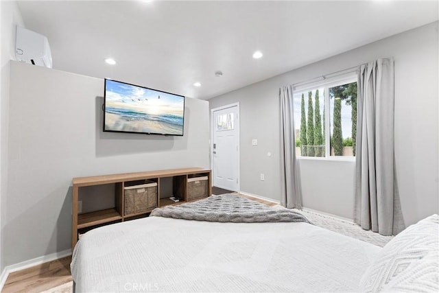 bedroom with recessed lighting, baseboards, and wood finished floors