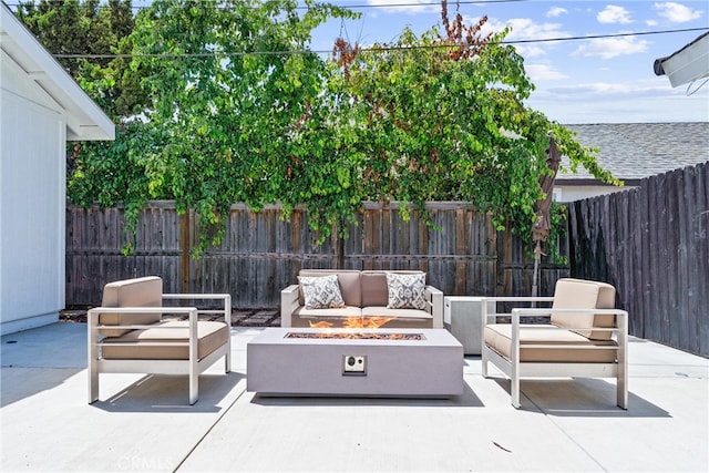 view of patio with an outdoor living space with a fire pit and a fenced backyard