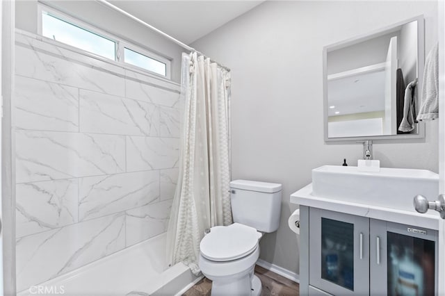 full bath featuring toilet, a stall shower, vanity, and wood finished floors