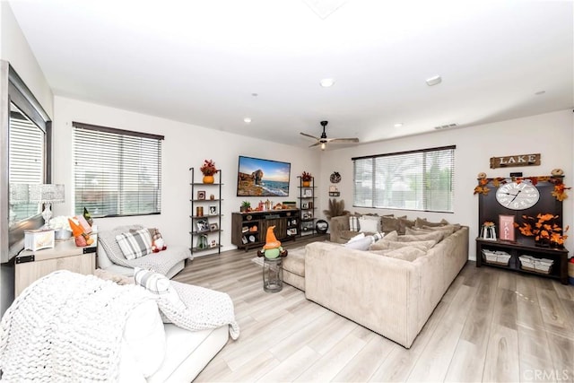 living area featuring light wood-style floors, a ceiling fan, and recessed lighting