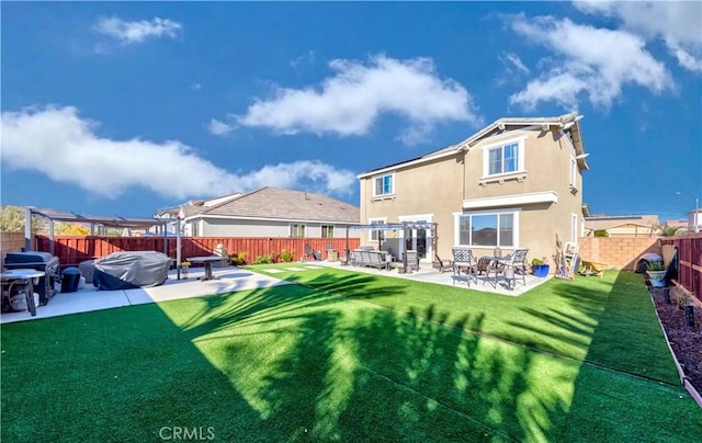 rear view of house featuring stucco siding and a patio area
