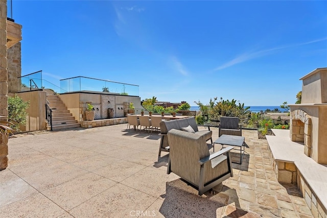 35 Shoreline Dr, Dana Point, CA 92629 - view of patio / terrace featuring outdoor dining area, stairs, and exterior fireplace