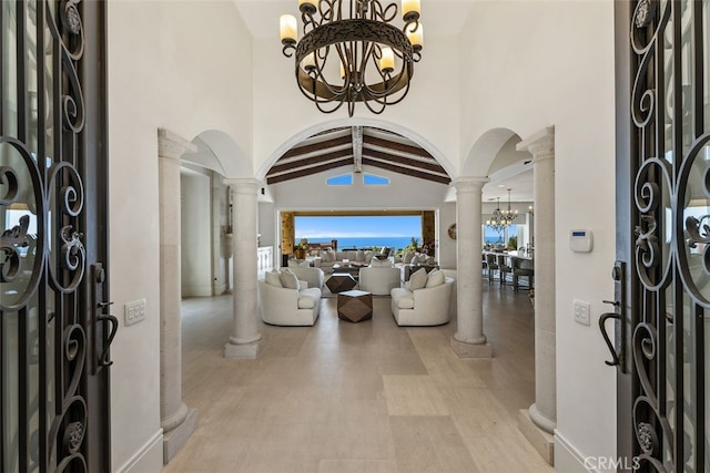 35 Shoreline Dr, Dana Point, CA 92629 - entrance foyer featuring decorative columns, arched walkways, a chandelier, and high vaulted ceiling