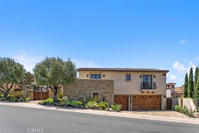 35 Shoreline Dr, Dana Point, CA 92629 - mediterranean / spanish-style house featuring a gate, a balcony, stucco siding, an attached garage, and driveway
