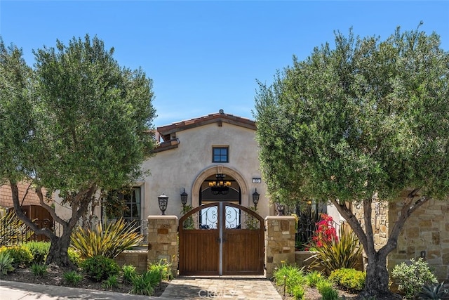 35 Shoreline Dr, Dana Point, CA 92629 - view of front of house featuring stucco siding, a fenced front yard, a gate, and stone siding