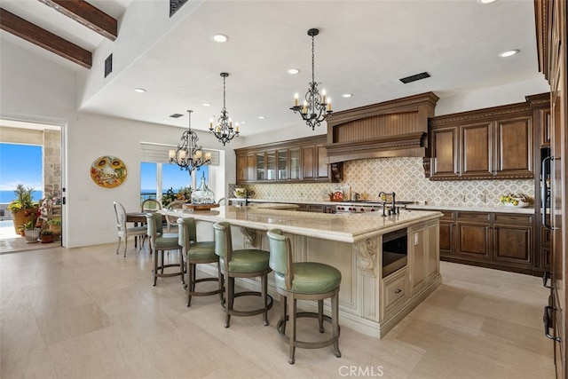 35 Shoreline Dr, Dana Point, CA 92629 - kitchen with tasteful backsplash, a spacious island, a chandelier, a kitchen breakfast bar, and decorative light fixtures
