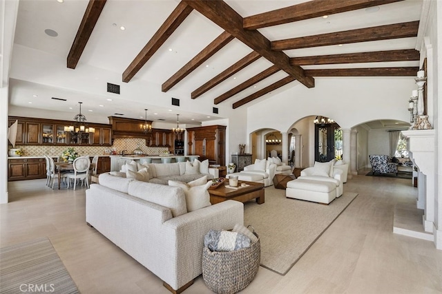 35 Shoreline Dr, Dana Point, CA 92629 - living area featuring arched walkways, a chandelier, beamed ceiling, recessed lighting, and light wood-style floors
