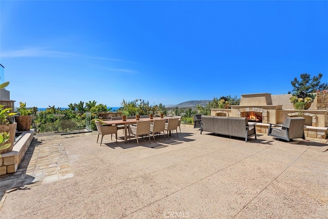 35 Shoreline Dr, Dana Point, CA 92629 - view of patio featuring outdoor dining area, an outdoor living space with a fireplace, and a mountain view