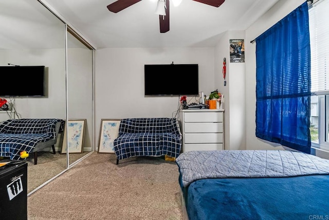 carpeted bedroom with a closet and a ceiling fan