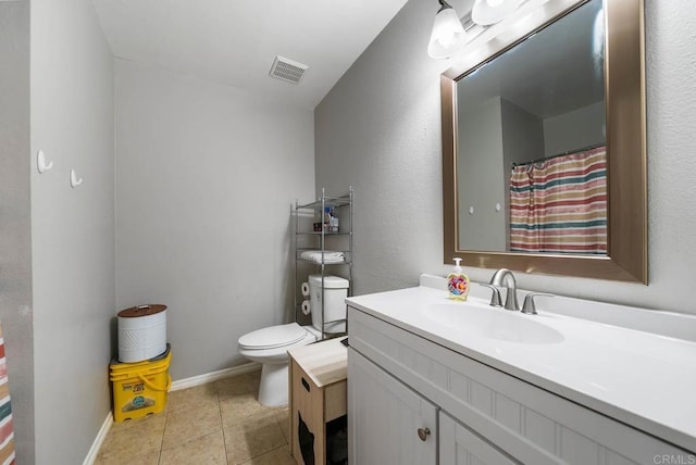 full bathroom featuring toilet, vanity, tile patterned flooring, and baseboards