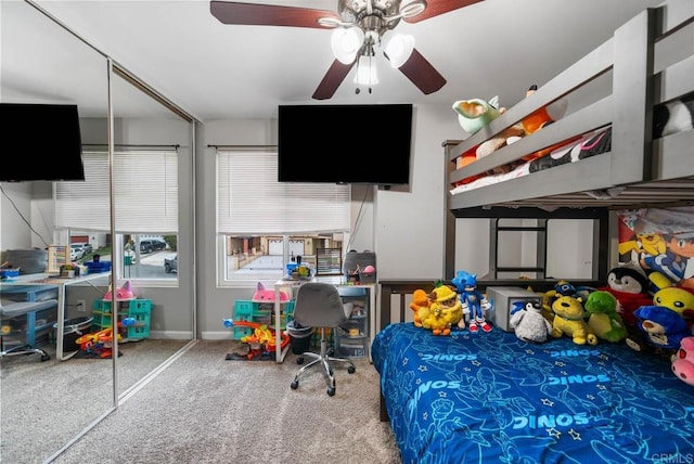 bedroom featuring carpet flooring, a ceiling fan, an office area, and baseboards