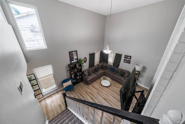staircase with wood finished floors and baseboards